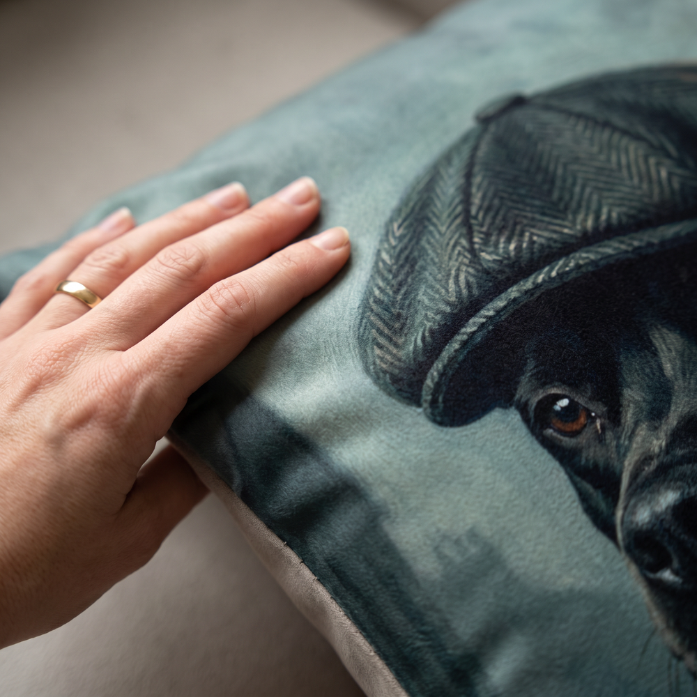 Close up of a hand on the soft-touch faux suede showing the 1920s Flat Cap print