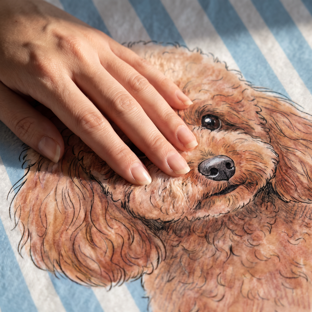 Close up of a hand on the ultra soft plush fleece showing the striped pet print