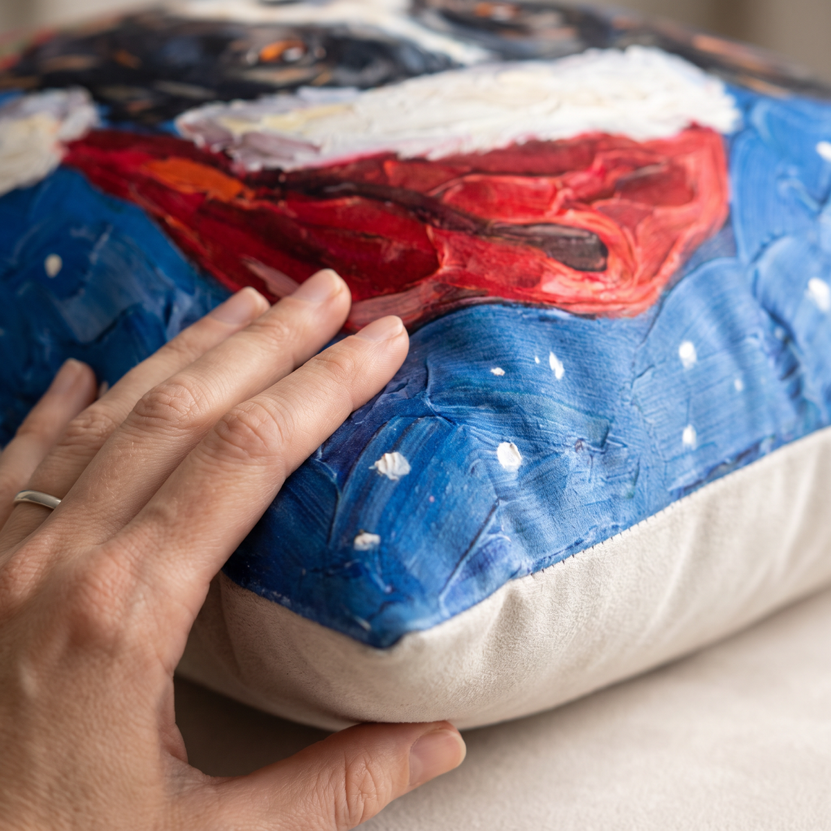 Close up of a hand on the soft-touch faux suede showing the Christmas print