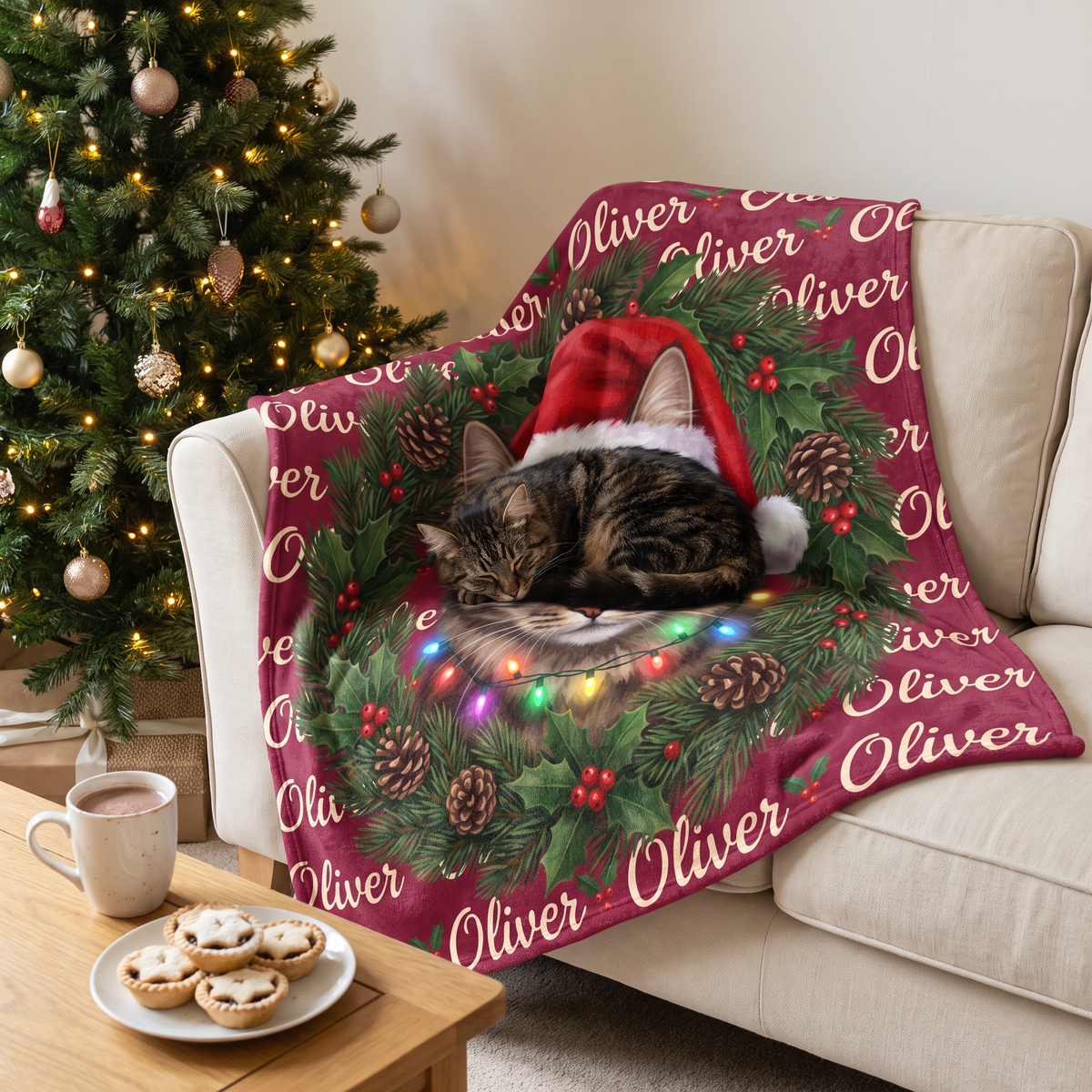 Tabby cat asleep on its Christmas wreath portrait blanket beside the Christmas tree